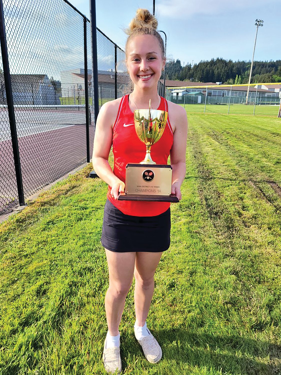 Megan Letts poses for a photo after winning the singles championship at the 1A District 4 girls tennis tournament at W.F. West High School in Chehalis on Tuesday.